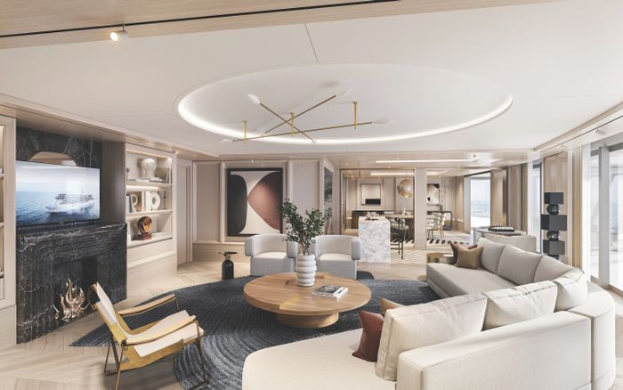 The expansive living room and dining areas in the Regent Suite aboard the 'Seven Seas Grandeur' are adorned with modern artwork and stylish furnishings.